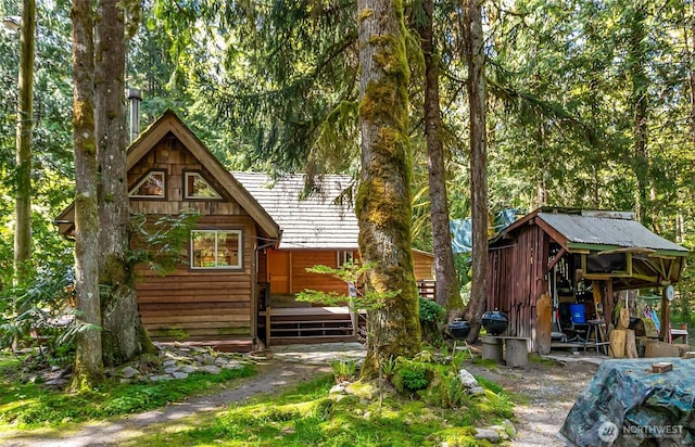 18242 643rd Ave NE Unit 54, 53, Baring, WA 98224 - rear view of property featuring a wooden deck and an outbuilding