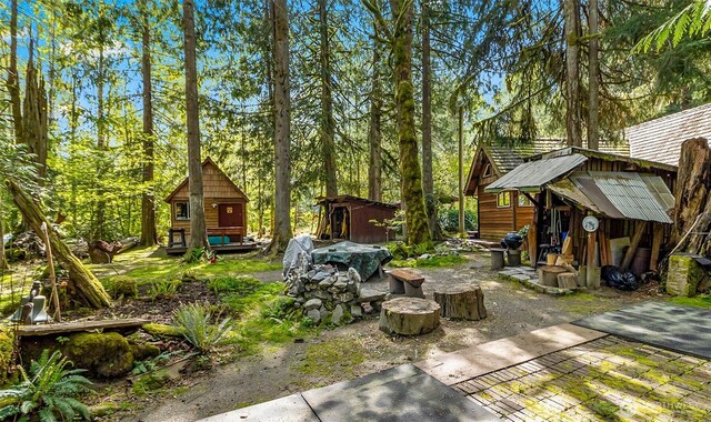 18242 643rd Ave NE Unit 54, 53, Baring, WA 98224 - view of patio featuring a storage shed and an outbuilding