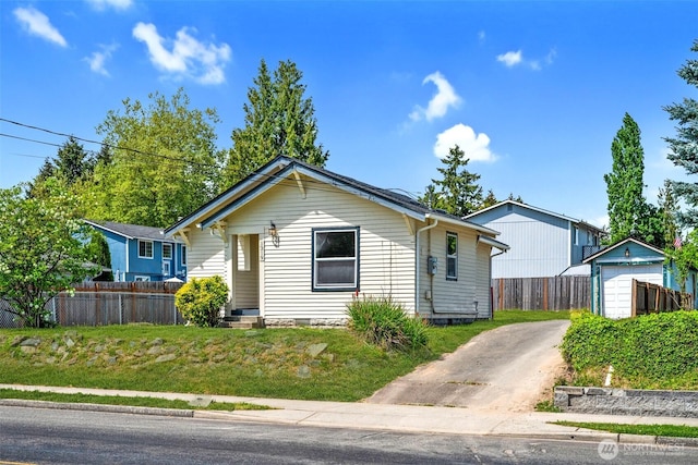 1319 E 56th St, Tacoma, WA 98404 - view of front facade with concrete driveway and fence