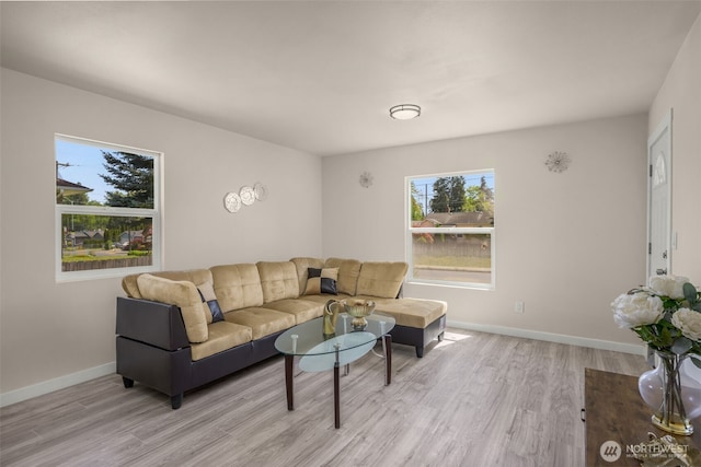 1319 E 56th St, Tacoma, WA 98404 - living room with healthy amount of natural light, light wood finished floors, and baseboards