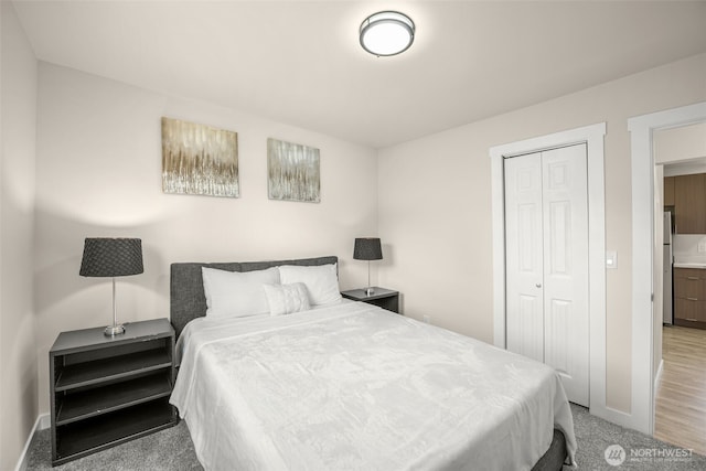 1319 E 56th St, Tacoma, WA 98404 - bedroom with a closet, carpet, freestanding refrigerator, and baseboards