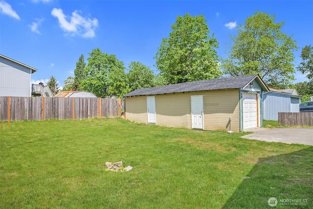 1319 E 56th St, Tacoma, WA 98404 - view of yard with an outbuilding, concrete driveway, and a garage