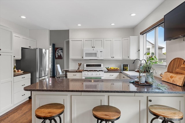 1438 NW 202nd Ln, Shoreline, WA 98177 - kitchen featuring white appliances, a sink, white cabinets, a peninsula, and recessed lighting