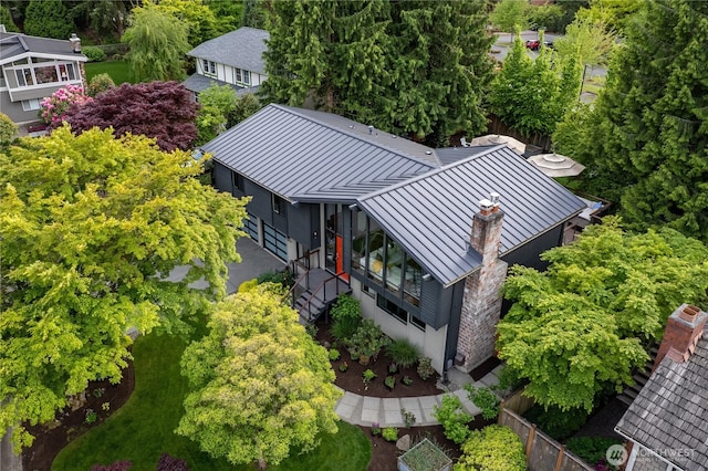 view from above of property with a tree filled landscape