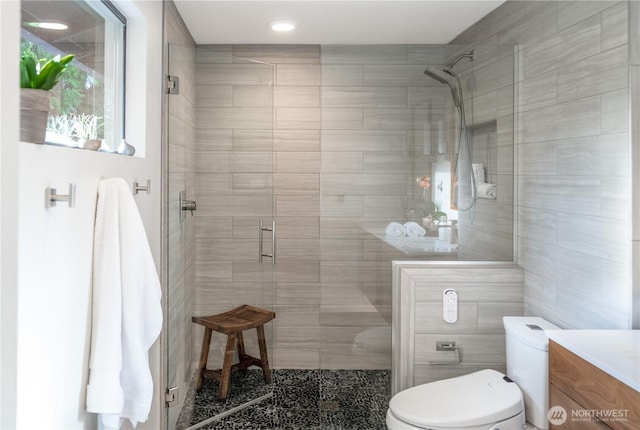 full bath with toilet, a shower stall, vanity, and recessed lighting