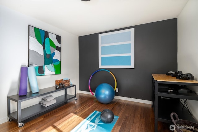 workout area with wood finished floors and baseboards