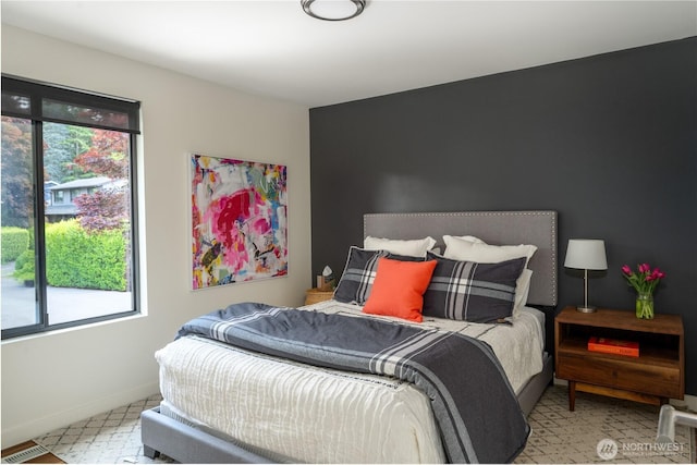bedroom featuring multiple windows and baseboards