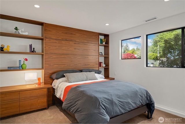 bedroom with light carpet, recessed lighting, and baseboards
