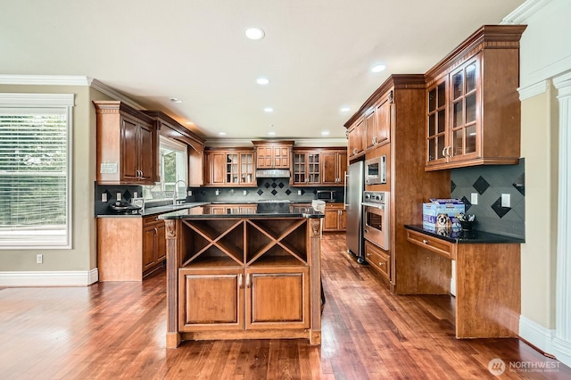 16925 SE 224th St, Kent, WA 98042 - kitchen featuring appliances with stainless steel finishes, dark countertops, a kitchen island, under cabinet range hood, and recessed lighting