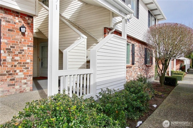 view of property exterior with brick siding
