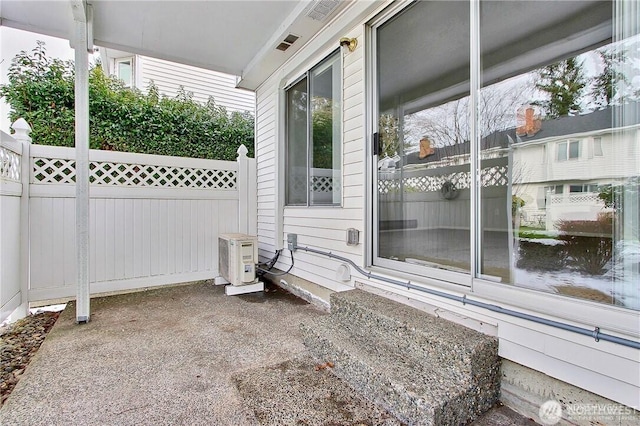 view of patio / terrace featuring fence and a cooling unit