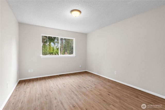 10320 16th St E, Edgewood, WA 98372 - unfurnished room featuring wood finished floors, baseboards, and a textured ceiling