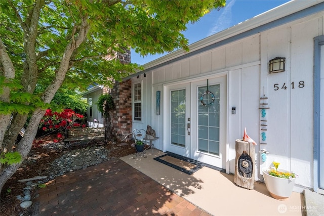 5418 Nootka Loop, Blaine, WA 98230 - doorway to property with french doors, a chimney, and a patio