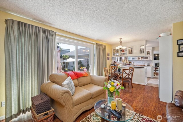 5418 Nootka Loop, Blaine, WA 98230 - living room with a chandelier, a textured ceiling, and wood finished floors