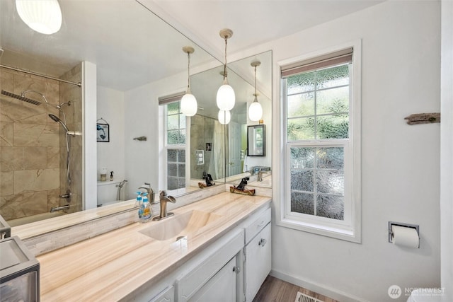5418 Nootka Loop, Blaine, WA 98230 - bathroom with vanity, healthy amount of natural light, baseboards, and wood finished floors