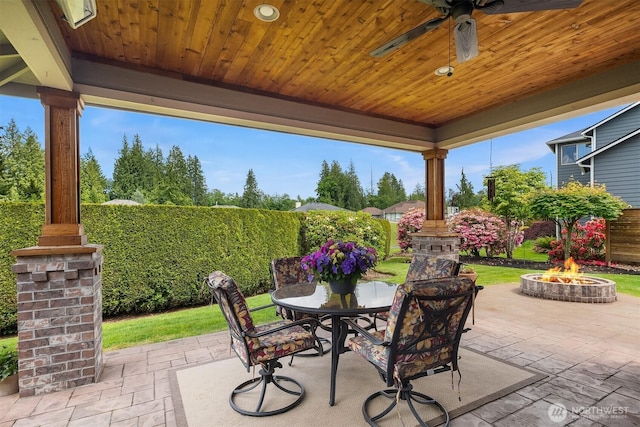 7528 Sterling Pl, Arlington, WA 98223 - view of patio with an outdoor fire pit, a ceiling fan, outdoor dining space, and a fenced backyard