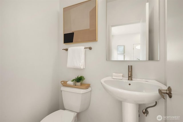 half bath featuring toilet