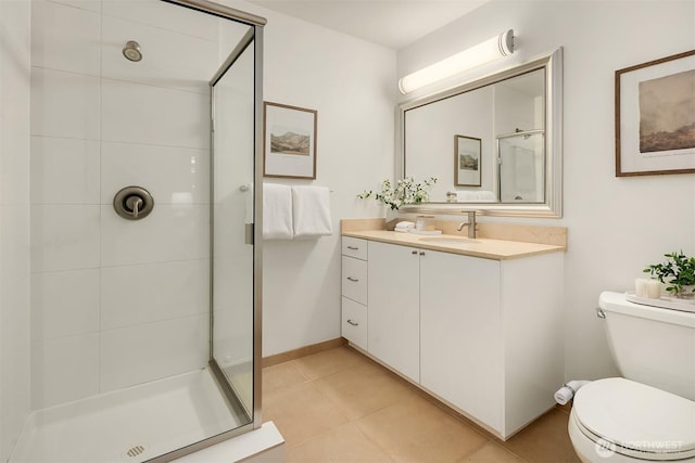bathroom featuring a shower stall, toilet, vanity, and tile patterned floors