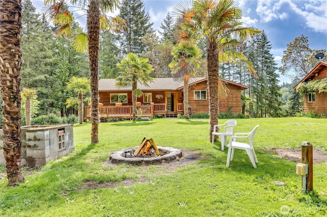 37611 Hansville Rd NE, Hansville, WA 98340 - view of grassy yard with a fire pit and a porch