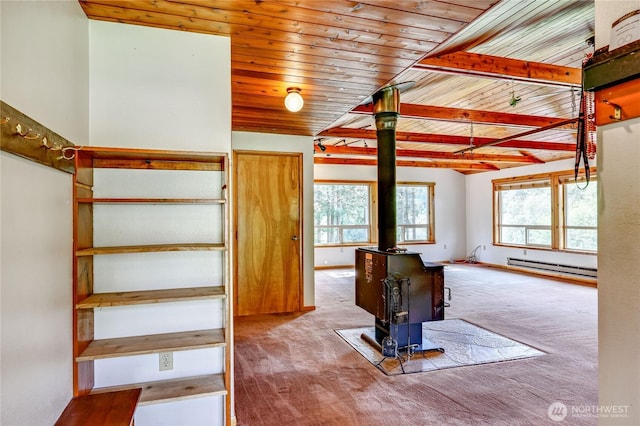 37611 Hansville Rd NE, Hansville, WA 98340 - staircase with a wood stove, baseboard heating, wood ceiling, and carpet floors