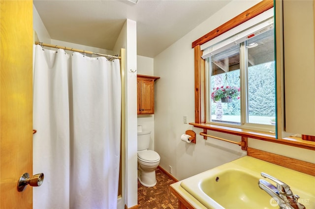 37611 Hansville Rd NE, Hansville, WA 98340 - bathroom featuring toilet, a sink, baseboards, and a shower with shower curtain