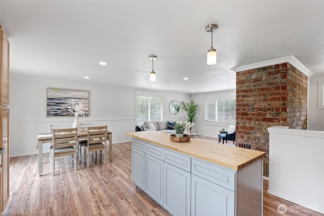kitchen with wooden counters, light wood-style flooring, decorative light fixtures, recessed lighting, and ornamental molding