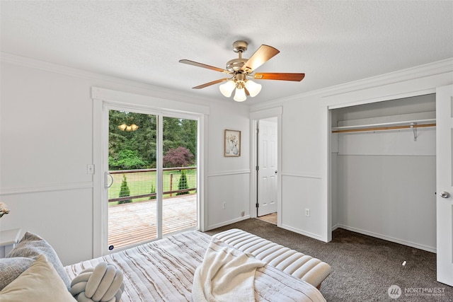 bedroom featuring dark carpet, ornamental molding, access to outside, a textured ceiling, and a closet