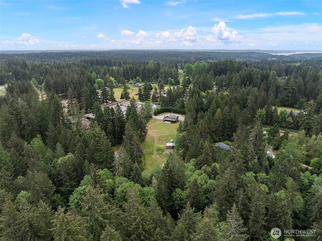 aerial view of property and surrounding area with a forest