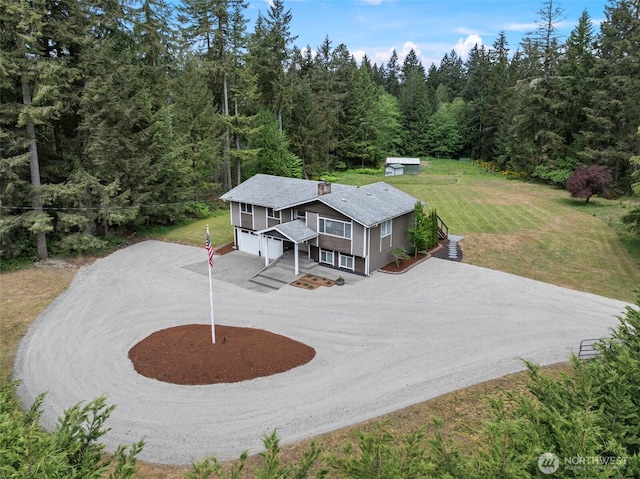 view of subject property with a heavily wooded area