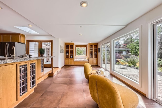 2545 NE 204th St, Shoreline, WA 98155 - kitchen with a skylight, freestanding refrigerator, tile counters, open floor plan, and recessed lighting