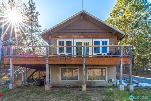 back of property featuring a wooden deck and stairway