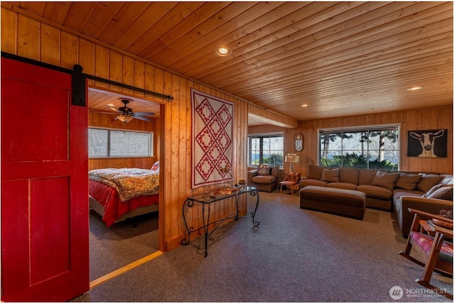 carpeted living room with wooden ceiling, wooden walls, and recessed lighting