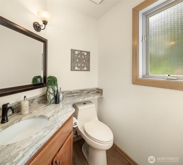 1118 2nd Ave S, Edmonds, WA 98020 - half bath featuring vanity, wood finished floors, toilet, and baseboards