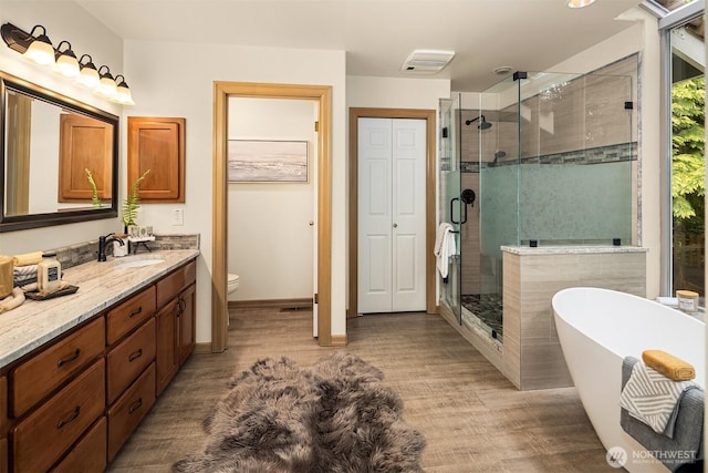 1118 2nd Ave S, Edmonds, WA 98020 - bathroom with a stall shower, vanity, wood finished floors, a freestanding bath, and toilet