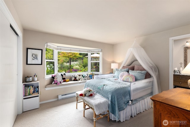 bedroom with a baseboard radiator, carpet floors, and a closet