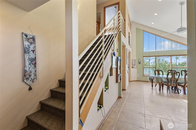 20501 Delta Rd NW, Soap Lake, WA 98851 - stairs featuring a high ceiling, tile patterned flooring, recessed lighting, a ceiling fan, and baseboards