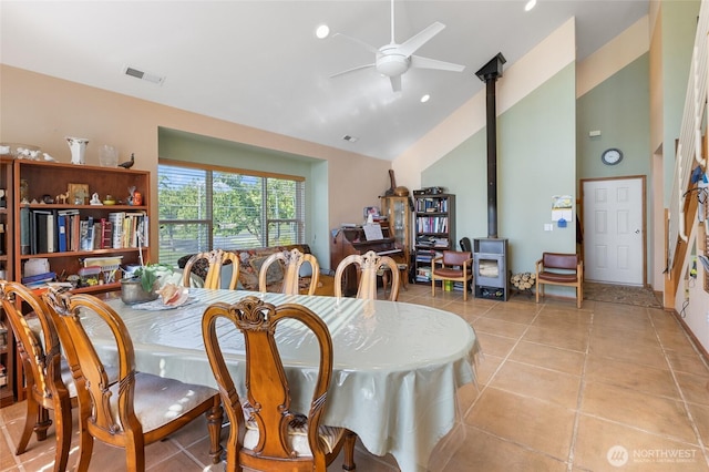20501 Delta Rd NW, Soap Lake, WA 98851 - dining area with a wood stove, a ceiling fan, high vaulted ceiling, and light tile patterned floors