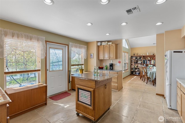 20501 Delta Rd NW, Soap Lake, WA 98851 - kitchen with freestanding refrigerator, healthy amount of natural light, a center island, recessed lighting, and light tile patterned floors