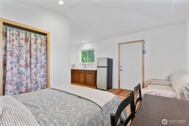 20501 Delta Rd NW, Soap Lake, WA 98851 - bedroom featuring freestanding refrigerator, a sink, light wood-style flooring, recessed lighting, and lofted ceiling