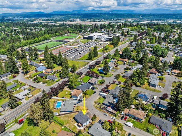 aerial view of property and surrounding area featuring a mountainous background