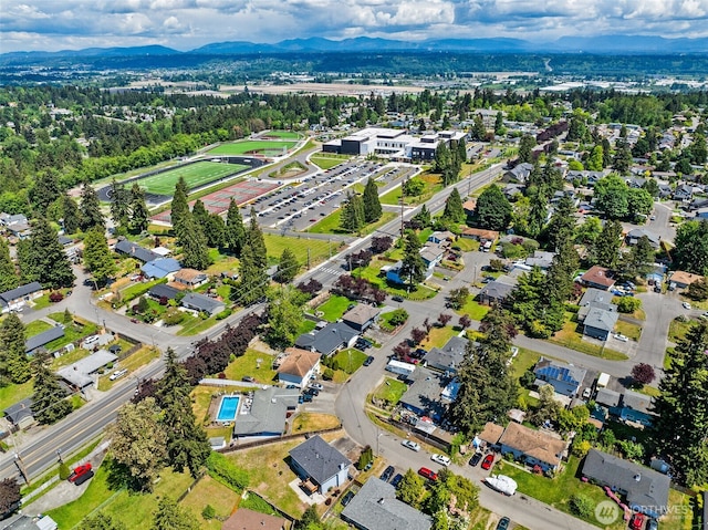 aerial view of property and surrounding area featuring a mountainous background