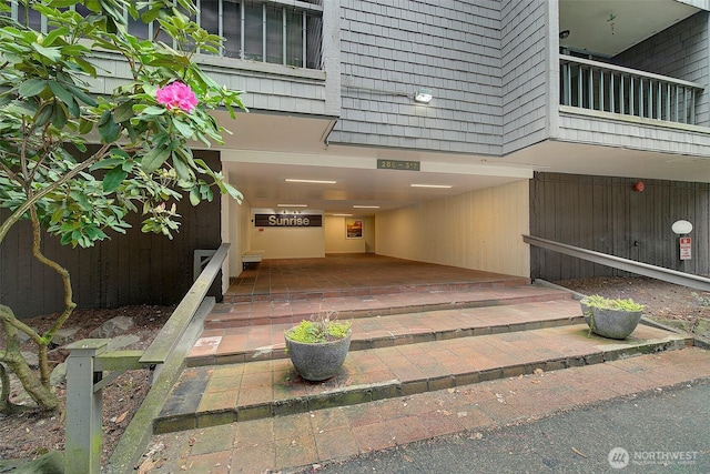 property entrance with a carport and a balcony