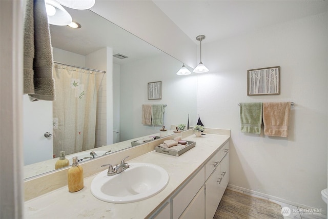 bathroom with toilet, vanity, baseboards, wood finished floors, and a shower with curtain