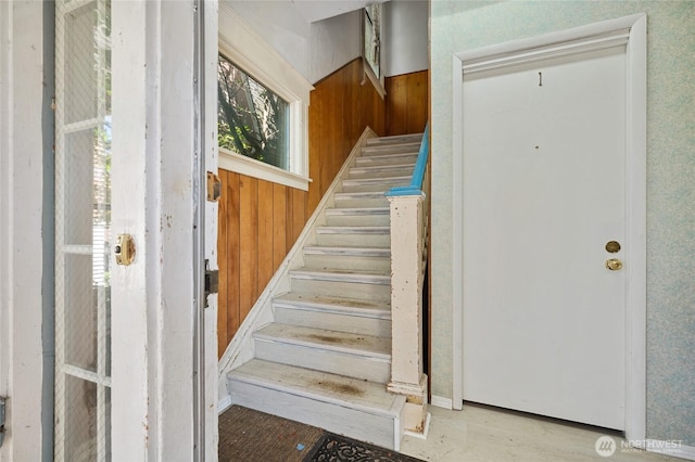 staircase with wood walls