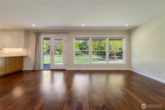 doorway to outside with plenty of natural light, baseboards, dark wood-style flooring, and recessed lighting