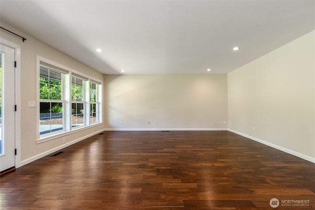 unfurnished room with dark wood finished floors, baseboards, and recessed lighting