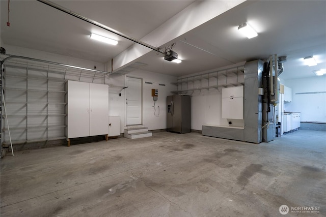 garage with refrigerator with ice dispenser and a garage door opener