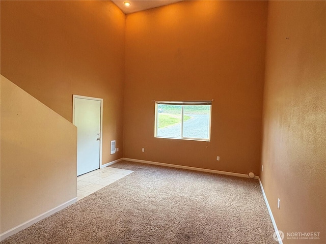 615 George Taylor Rd, Silverlake, WA 98645 - unfurnished room featuring light carpet, a high ceiling, and baseboards