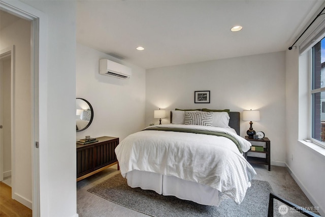 bedroom featuring a wall unit AC, baseboards, and recessed lighting