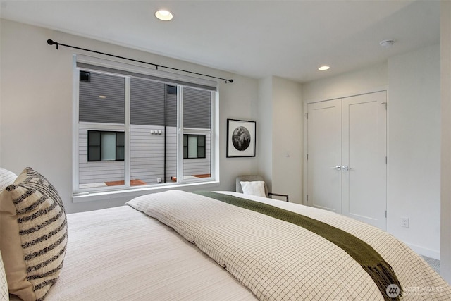 bedroom with recessed lighting and a closet